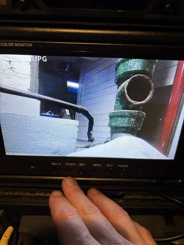 Sewer camera monitor displaying pipe footage