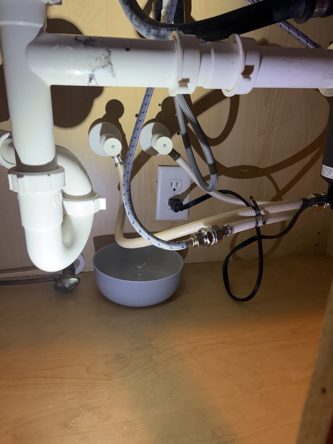 Before: old sink shutoff valves with a bowl underneath to catch leaking water