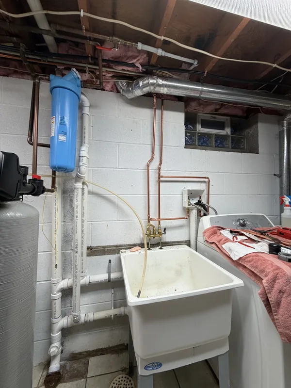 Copper supply lines and water filtration housing installed in a utility room
