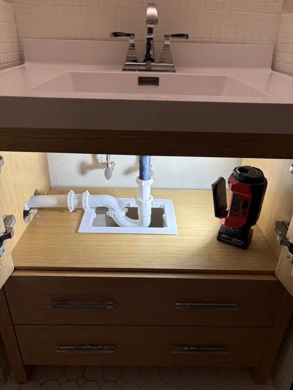 Vanity faucet and drain trim reinstalled after a bathroom sink repair