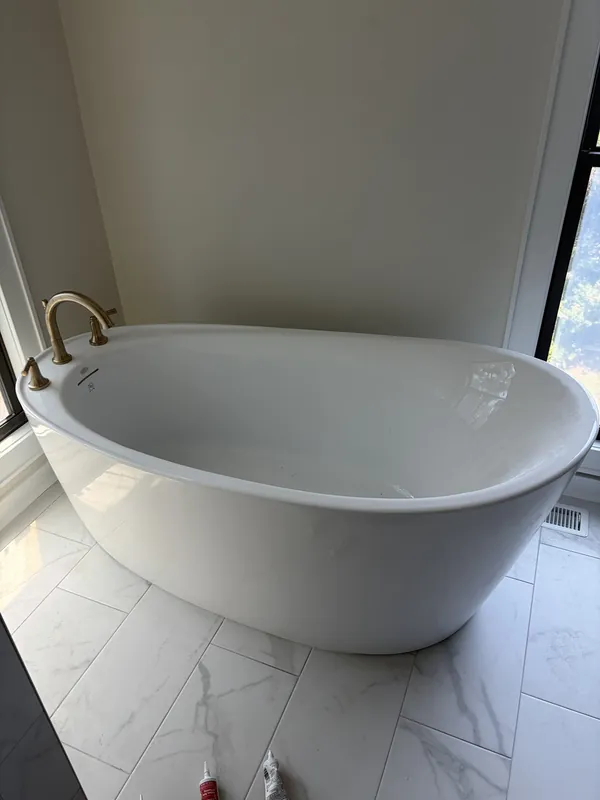 Freestanding tub plumbed and set during a bathroom remodel